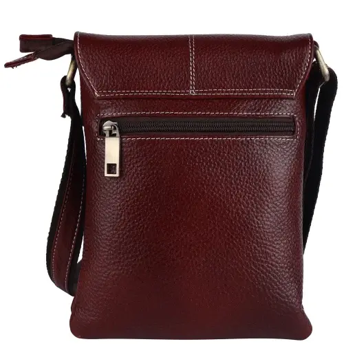 Dark brown grained leather sling bag with a zipped front pocket and contrast stitching